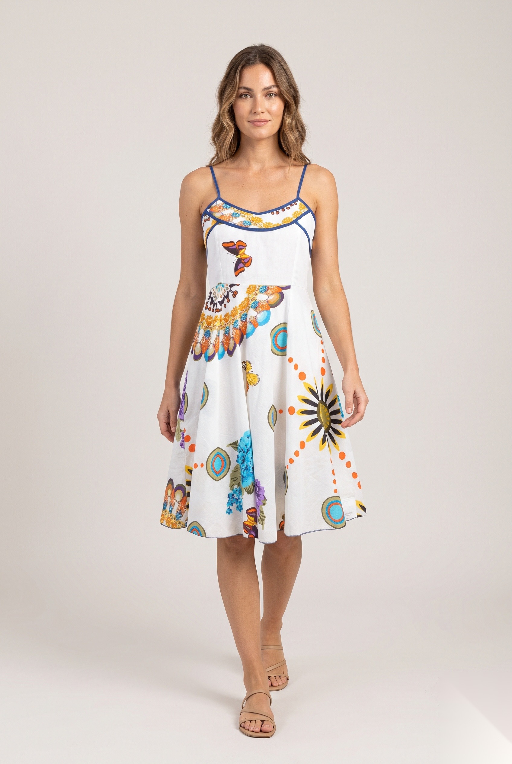 White sun and floral print sundress with navy piping worn by a model, KK Fashion Exports