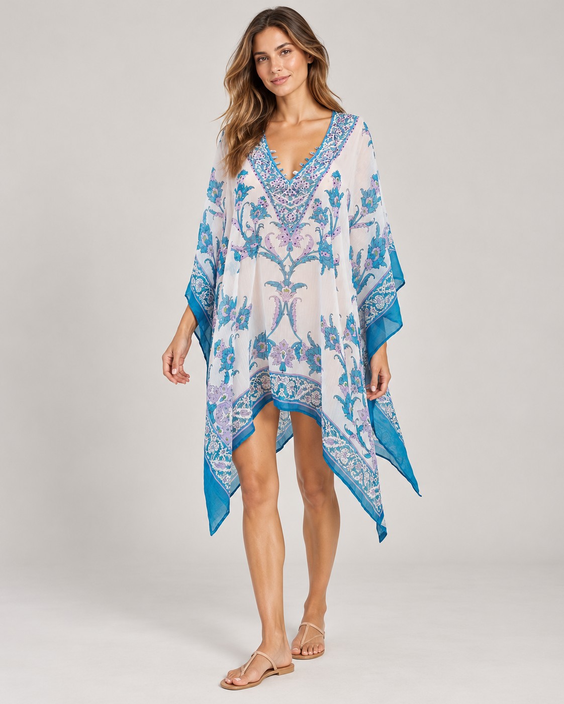 White and blue floral print poncho with blue border worn by a model, KK Fashion Exports