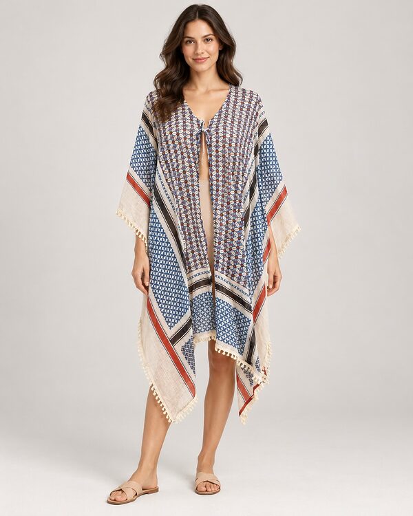 Blue and cream print open poncho with pom-pom trim worn by a model, KK Fashion Exports
