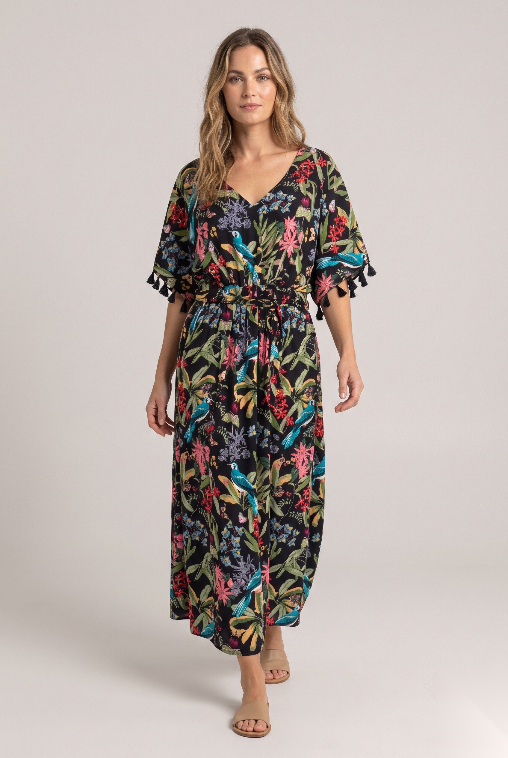 Black tropical bird print maxi beach dress with tassel sleeves worn by a model, KK Fashion Exports
