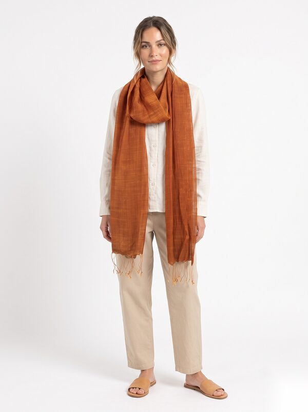 Burnt orange silk solid stole with fringe worn by a model, KK Fashion Exports