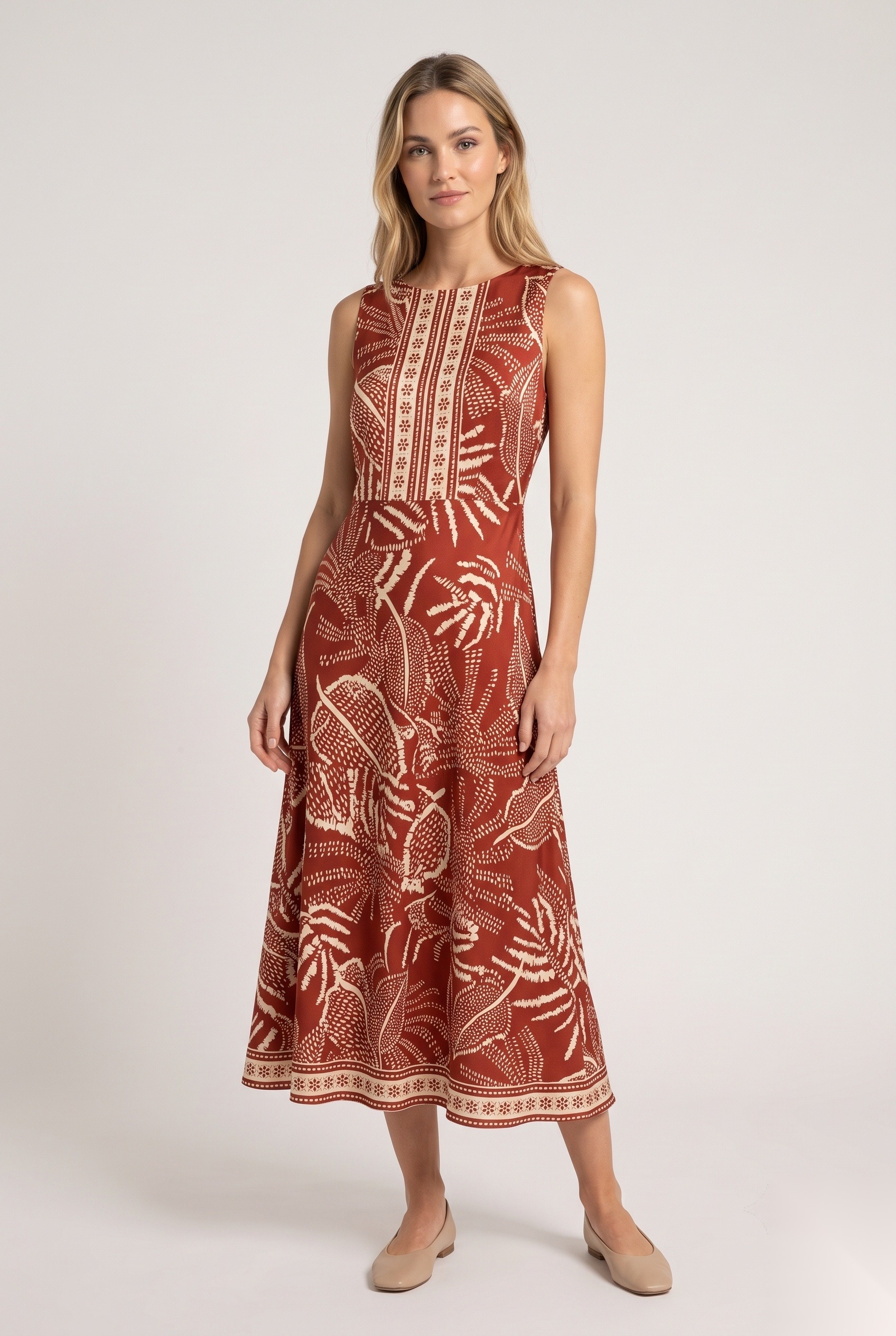 Silk sleeveless A-line midi dress in a dense tropical foliage with veined leaves and decorative border trim print.