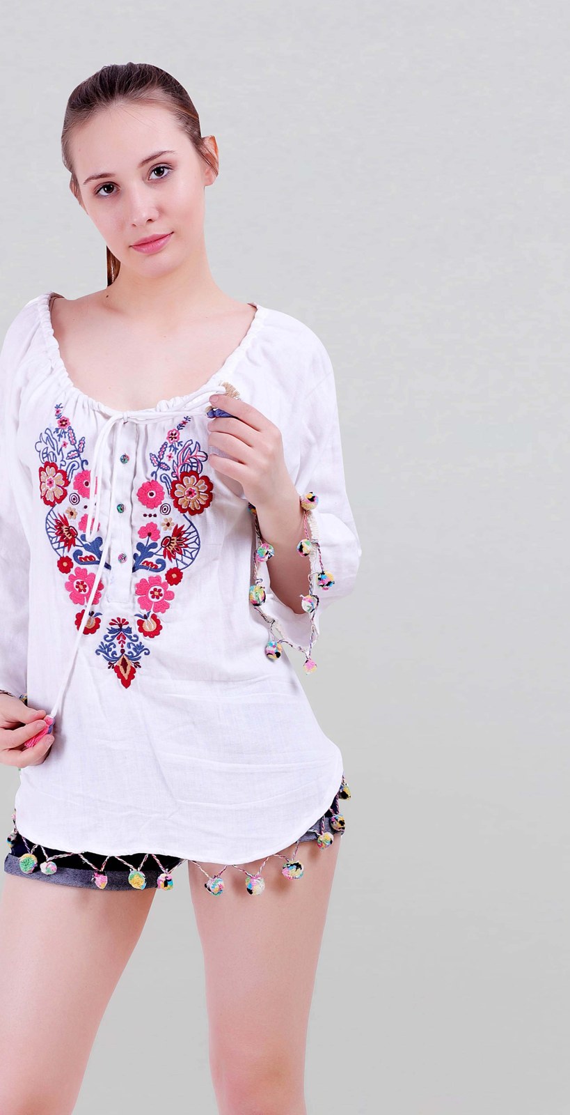 White cotton top with colourful floral embroidery on the yoke
