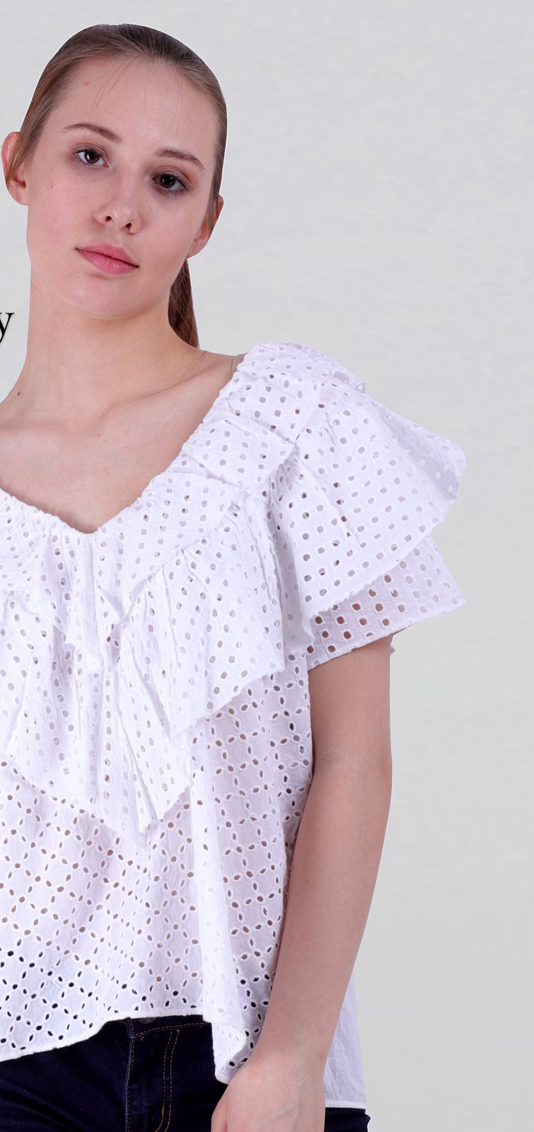 White cotton eyelet embroidery top with a ruffle front