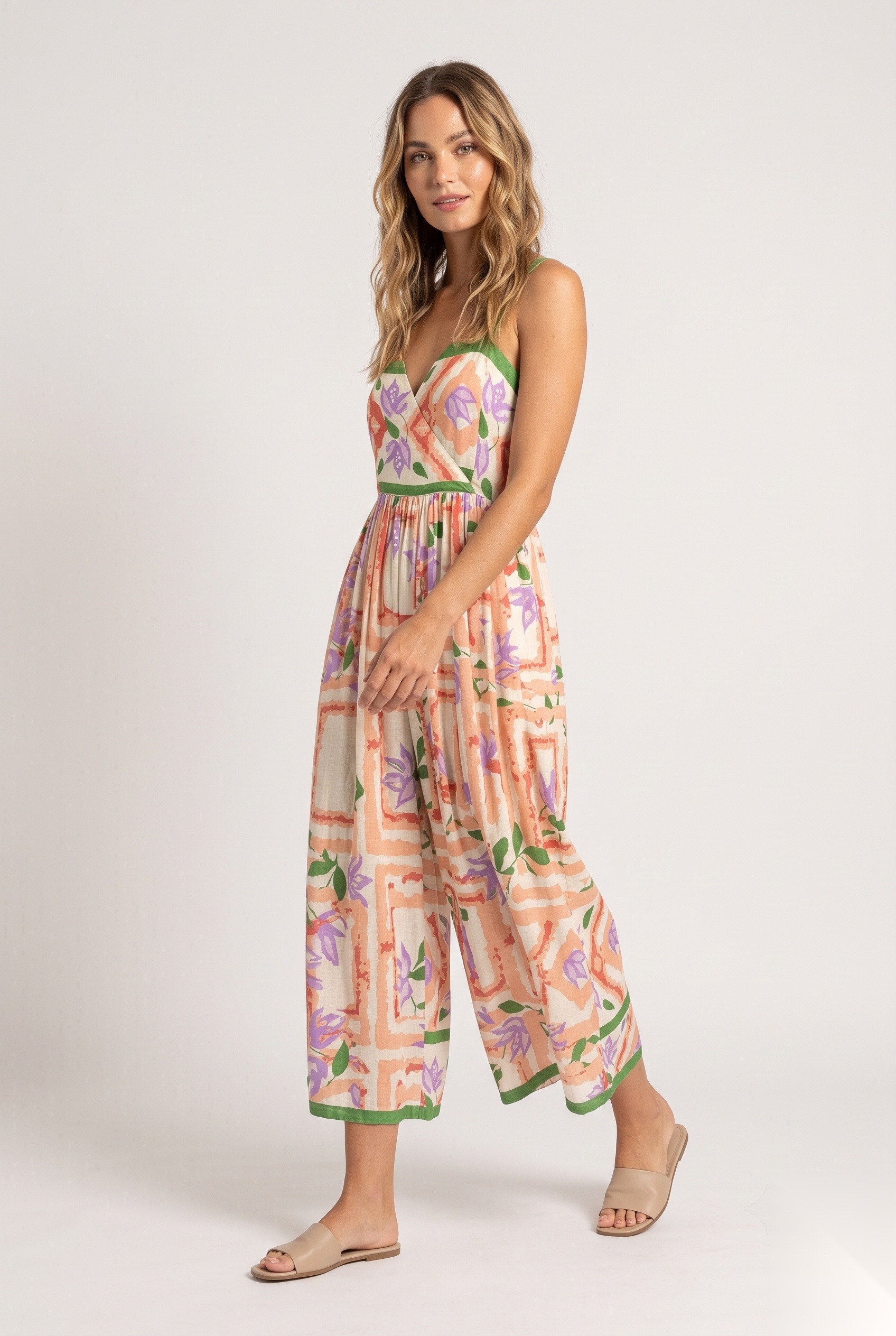 Linen wrap-front culotte jumpsuit in a stylized flowers layered over abstract geometric frame grid print.