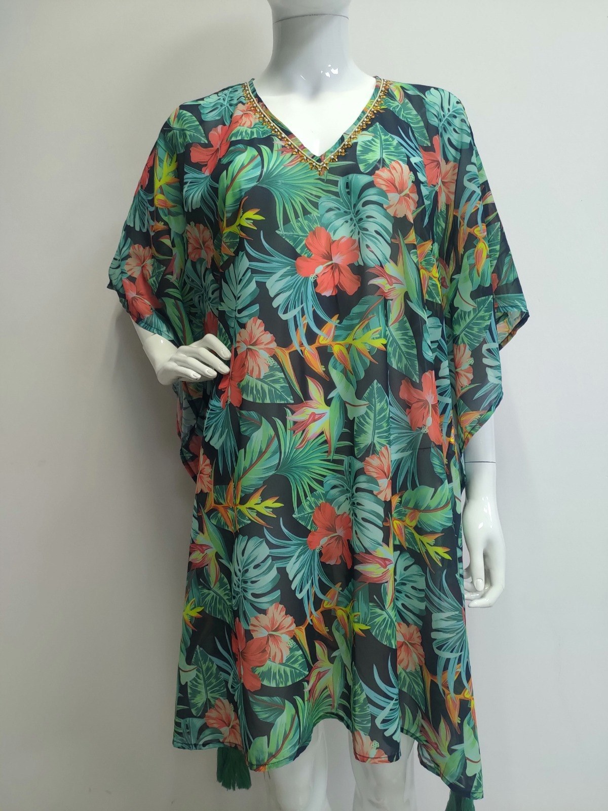 Green tropical floral kaftan on a mannequin