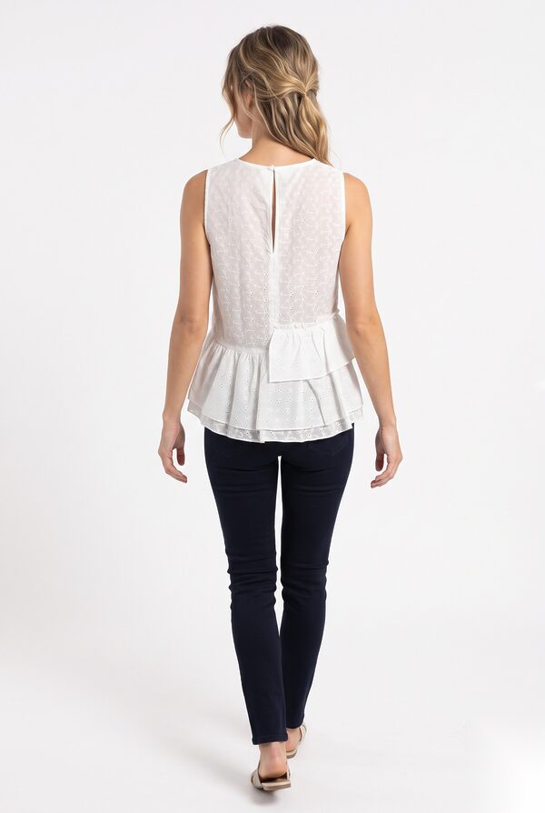 White eyelet embroidered net top with tiered peplum, back view worn by a model, KK Fashion Exports