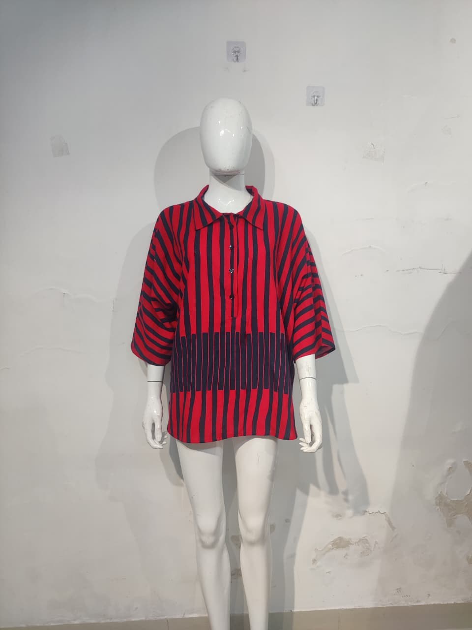 Red and navy printed top on a mannequin