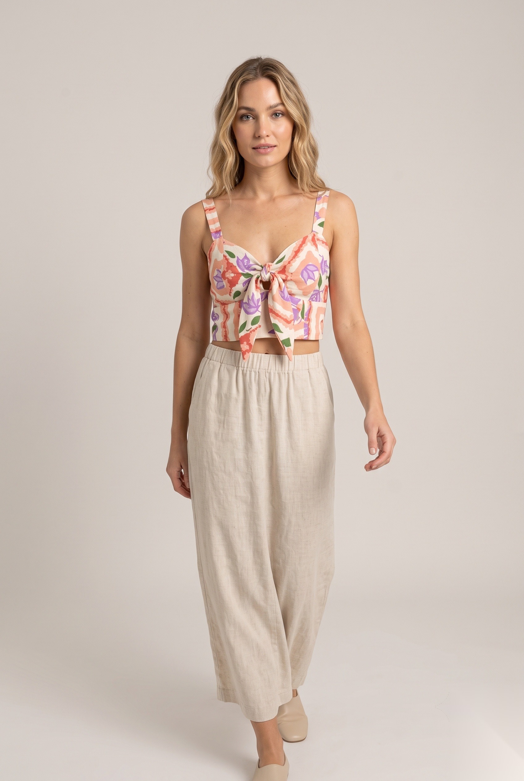Linen tie-front crop top in a stylized flowers layered over abstract geometric frame grid print.