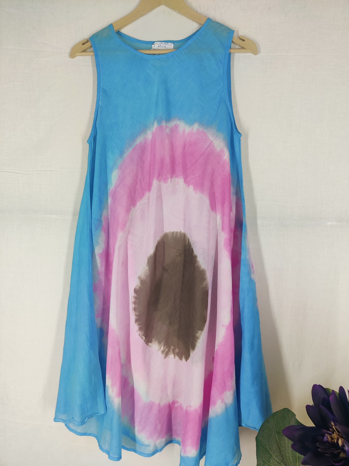 Blue and pink tie-dye sleeveless umbrella dress on a hanger