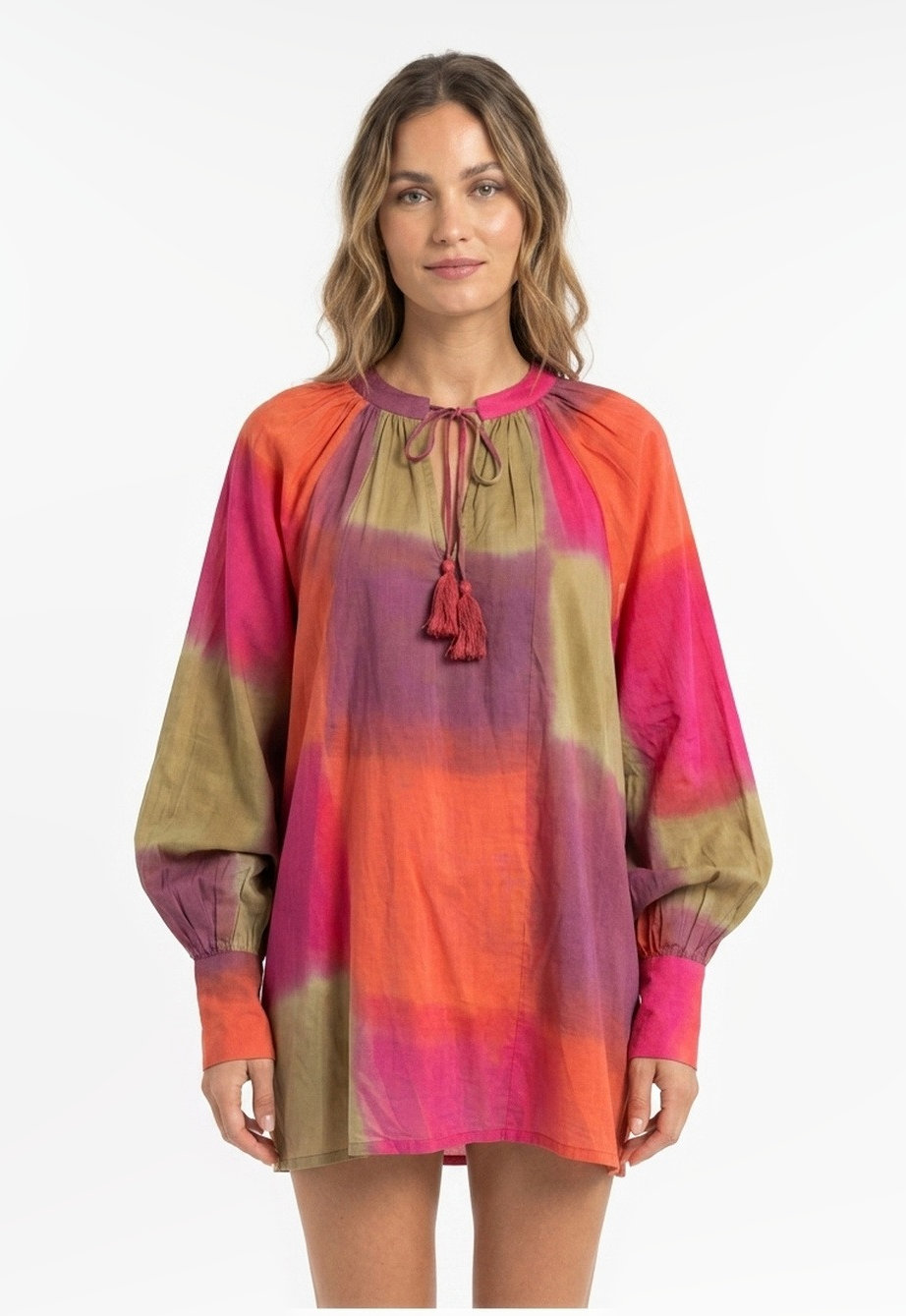 Short cotton dress with balloon sleeves and a tassel tie neck in a pink, orange and olive ombre-dyed print.