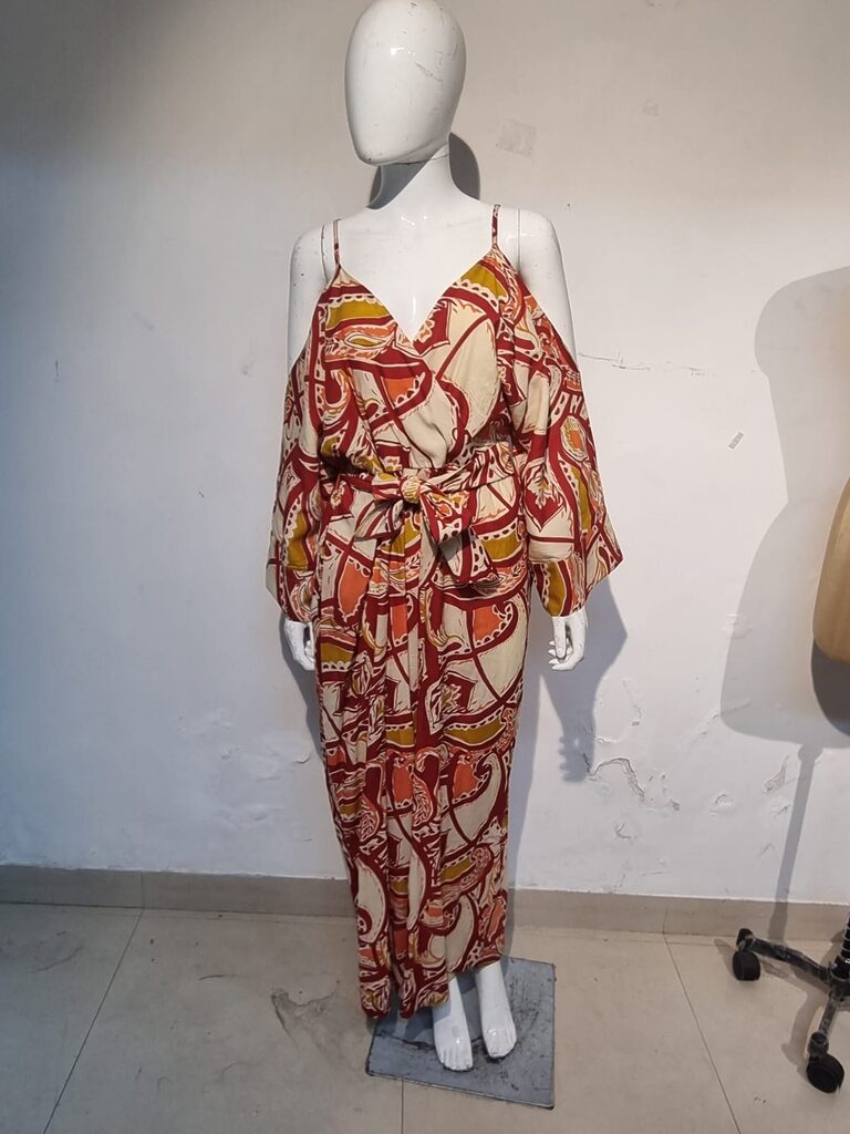 Red and cream print jumpsuit on a mannequin