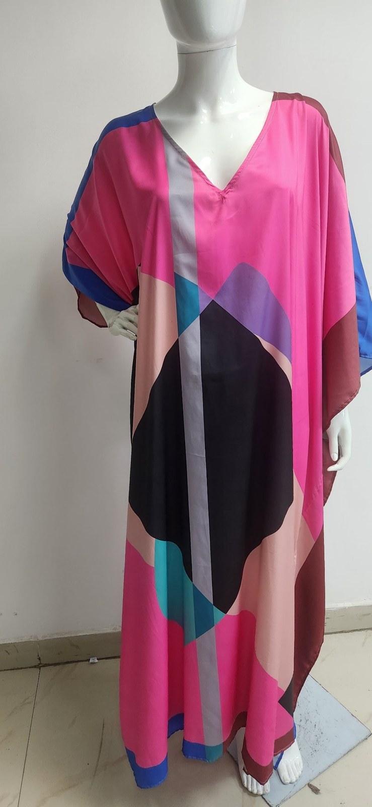 Long kaftan in a bold digital colour-block print on a mannequin