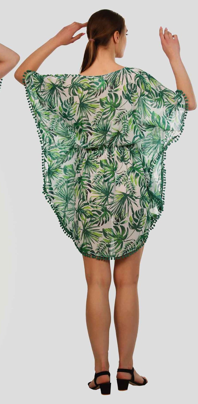 Back view of a green leaf print kaftan with pom pom hem