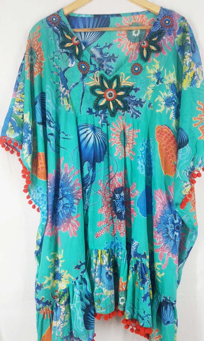 Turquoise floral kaftan with pom pom trim on the hem