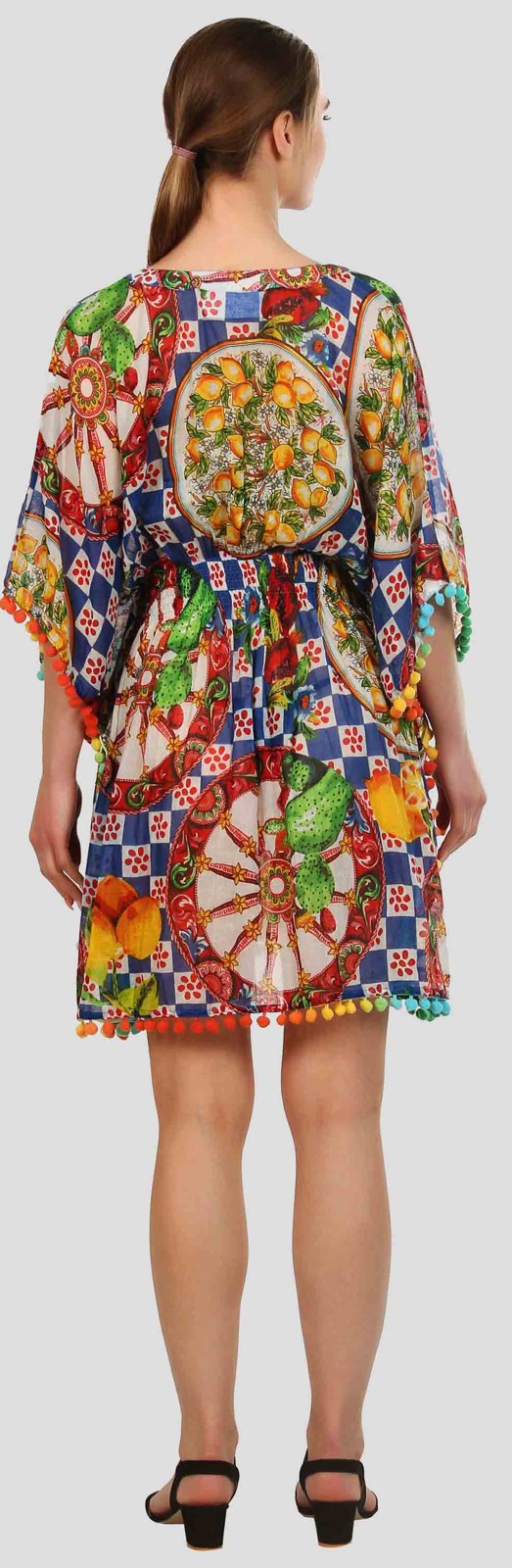 Back view of a bright printed kaftan with pom pom trim