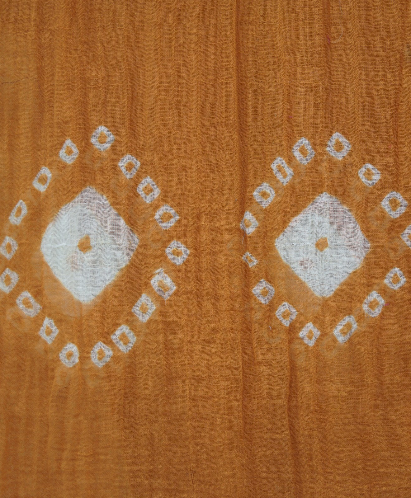 Rust shibori tie-dye cotton scarf laid flat