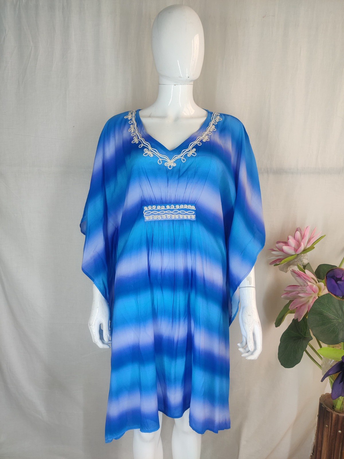 Blue ombre-striped kaftan with white cord embroidery trim at the neckline and waist