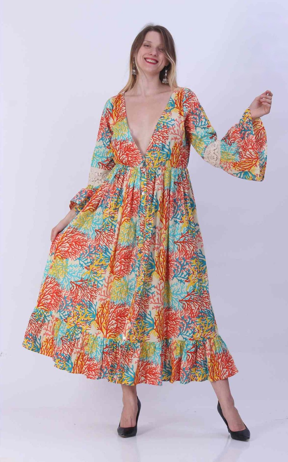 Woman in a cotton maxi dress with a multicolour coral reef print and bell sleeves
