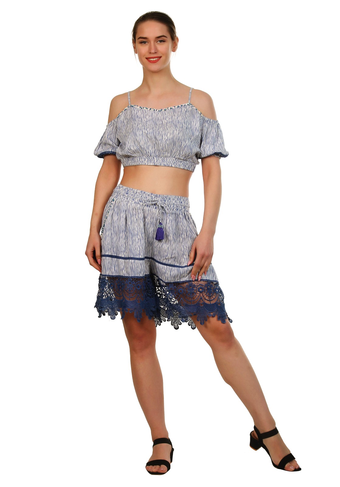 Woman in a blue and white striped co-ord set of a cold-shoulder crop top and lace-trimmed shorts